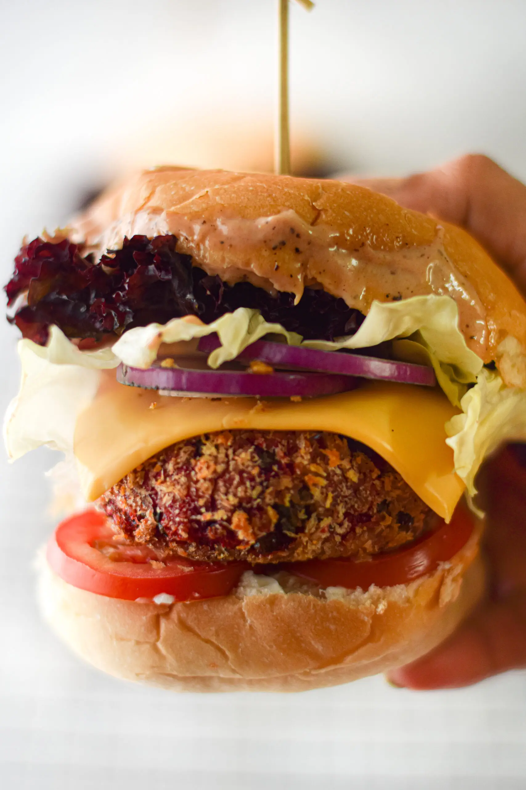 air fryer veggie burger with all the fixings on a bun