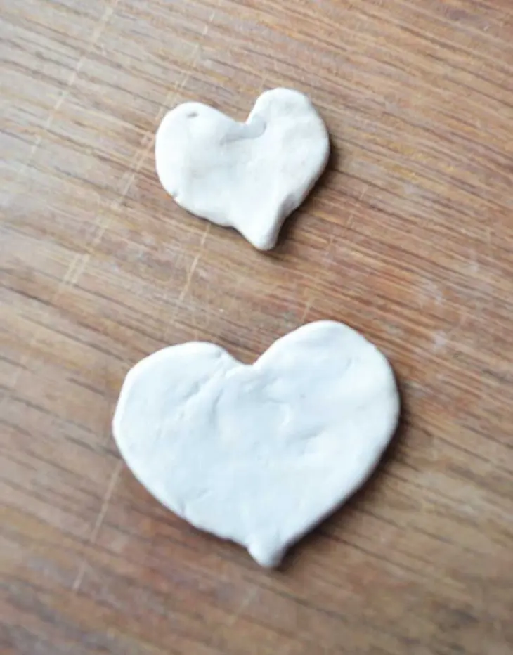 easy clay heart bookmarks. These are made with air-dry clay found at your local store. They are easy to make and great to personalize for Valentine's day with your child's thumbprint! Great idea for gifts.