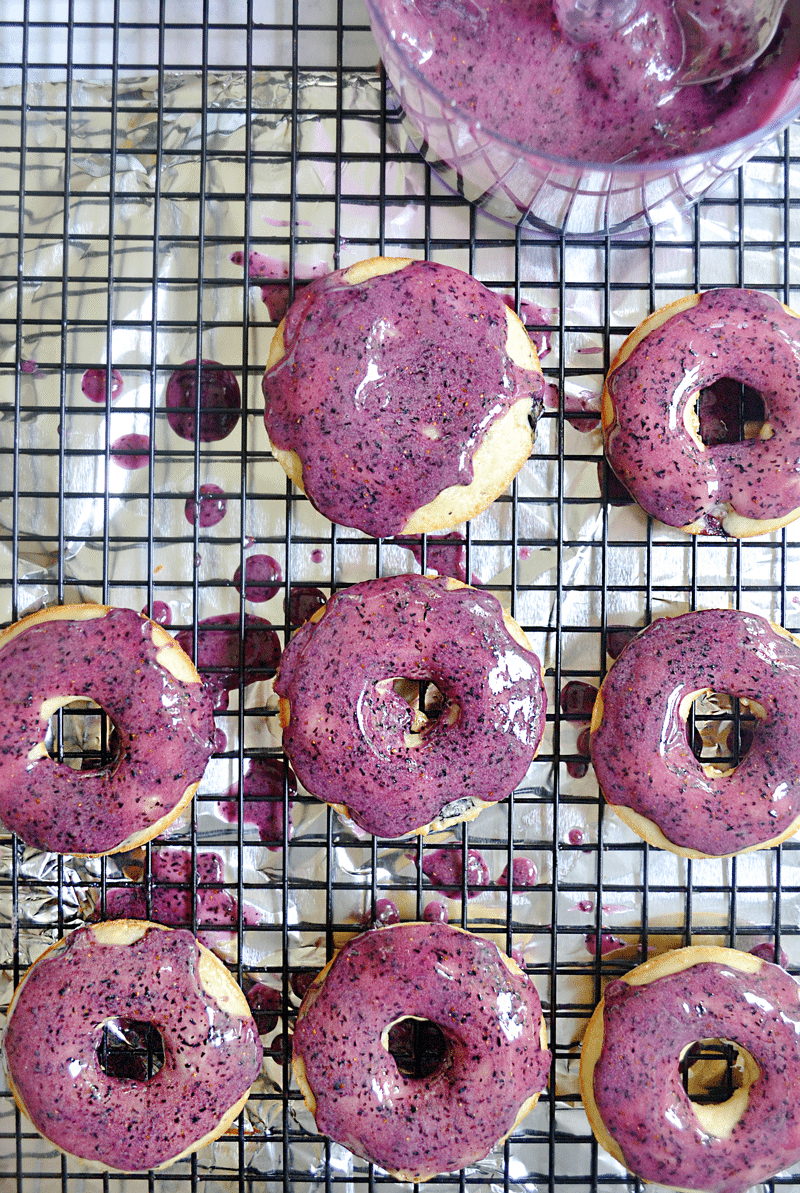 These baked yogurt donuts with fresh blueberry icing are fast and easy for busy parents! Kid's love them because of their sweet and bright blueberry flavor AND fantastic color. You'll love them because you can make them up in under 20 minutes.