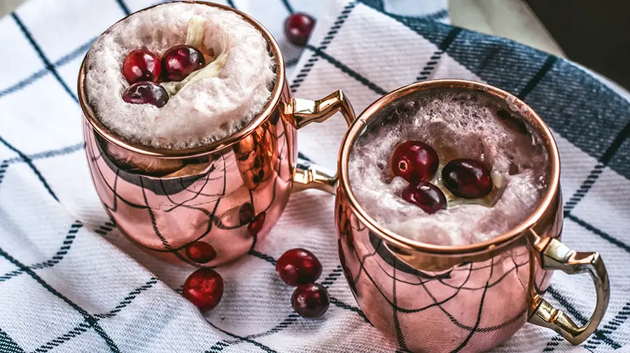 Cranberry moscow mule recipe. Easy to make and so pretty to serve! Add a scoop of vanilla ice cream and turn this into a festive dessert!