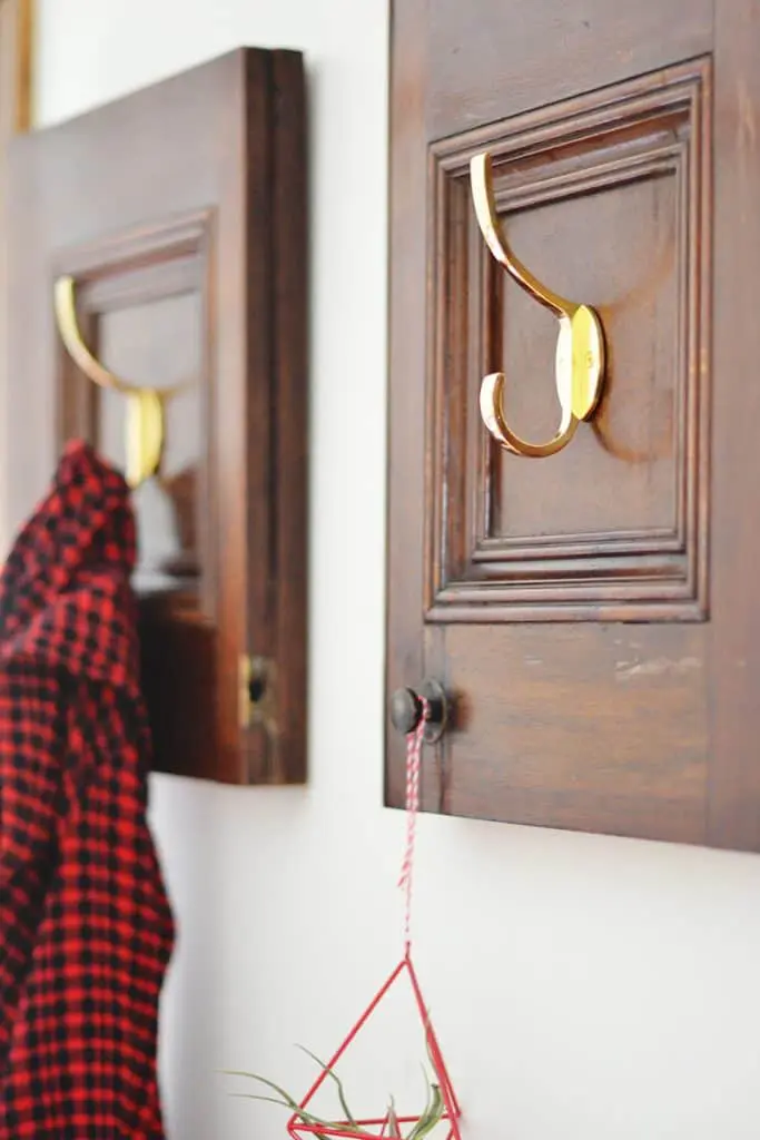 Repurposed cabinet doors into a charming coat rack in 3 easy steps! A DIY anyone can do!