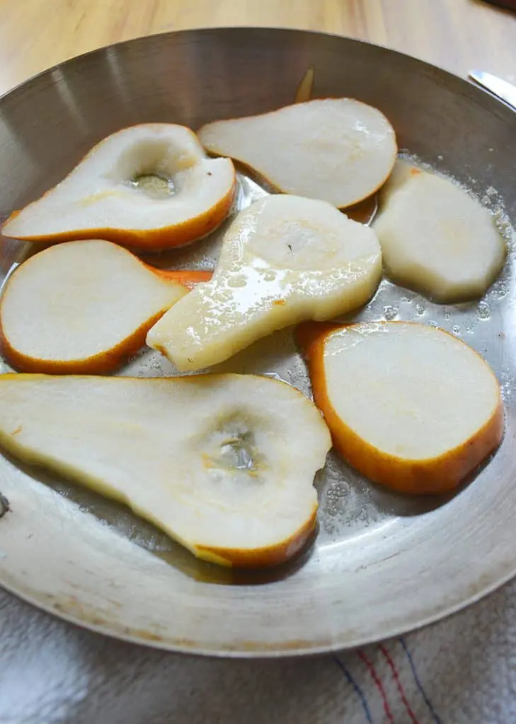 Pears being poached for a pear cake