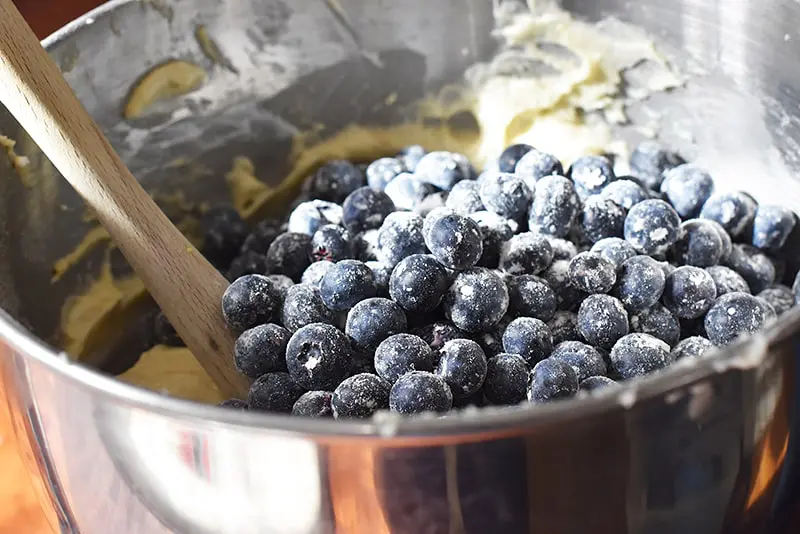 fold the blueberries gently into the blueberry sour cream bundt cake batter