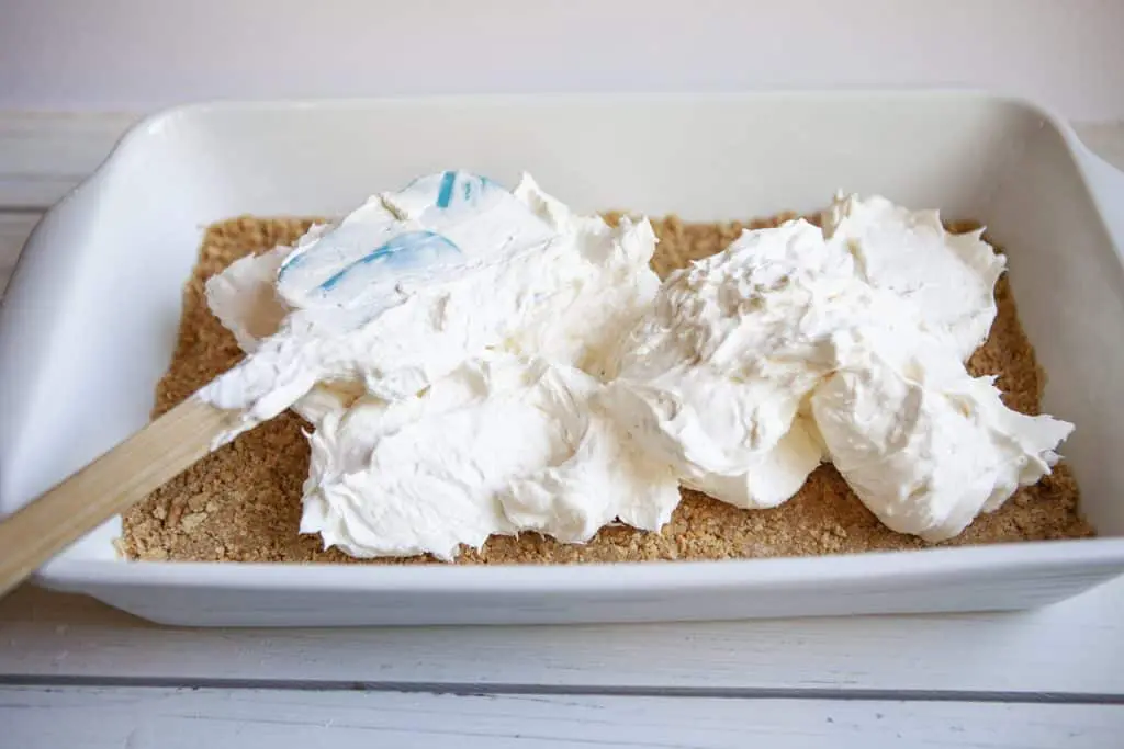 no bake cherry cheesecake filling spread over the crust