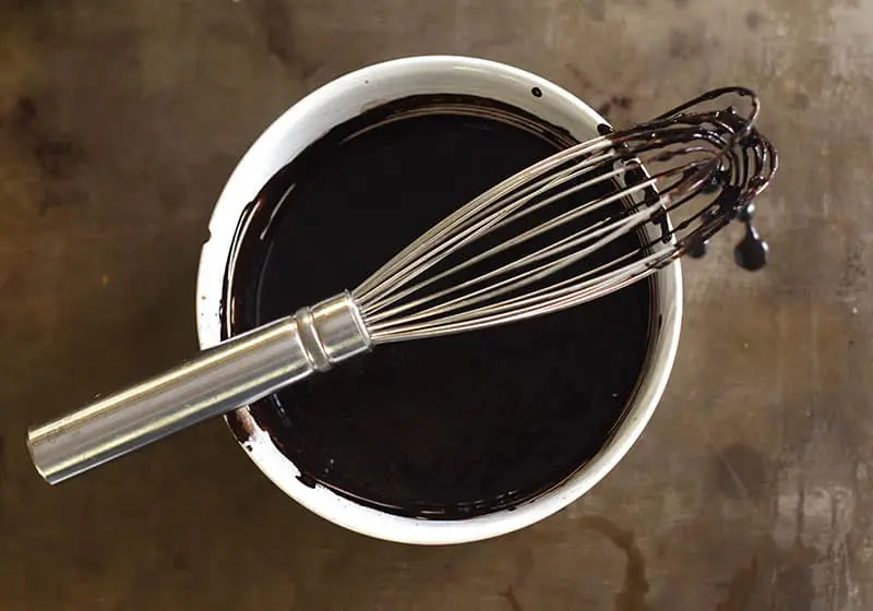 whisking the black cocoa for the chocolate cake