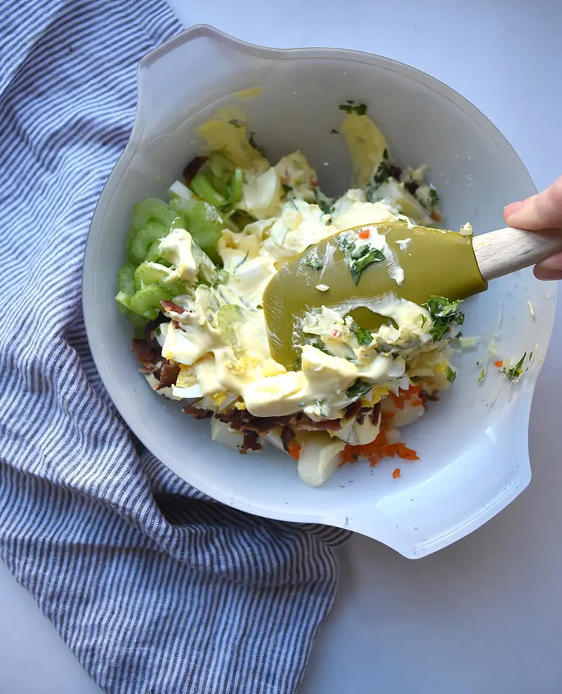 mix creamy dressing with potato salad ingredients for a delicious deviled egg potato salad