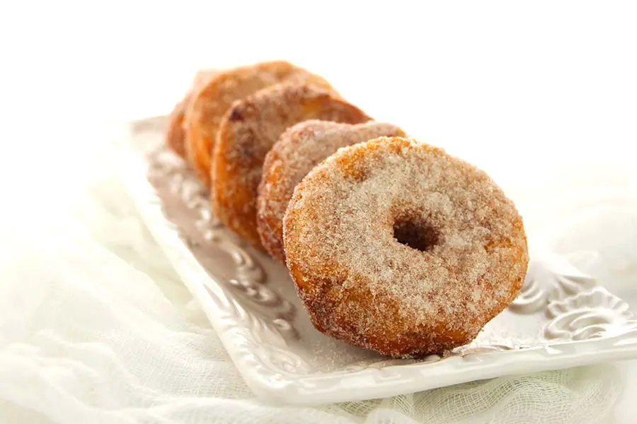 These homemade donuts are made with canned biscuits and covered in cinnamon and sugar.