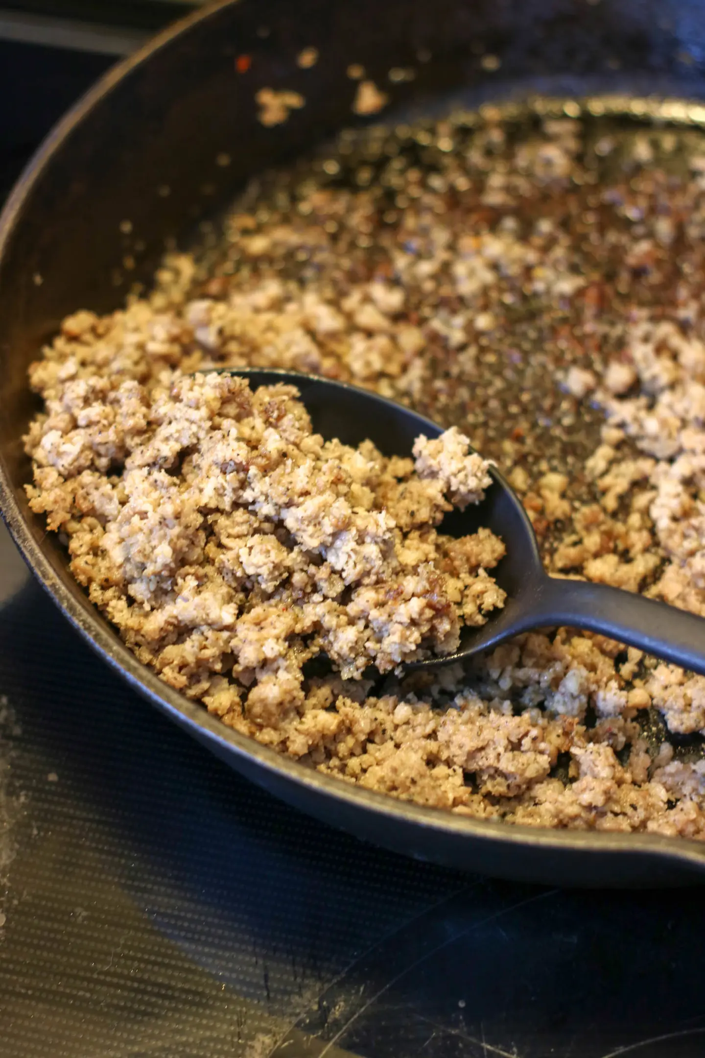 Ground sausage cooked in a skillet.