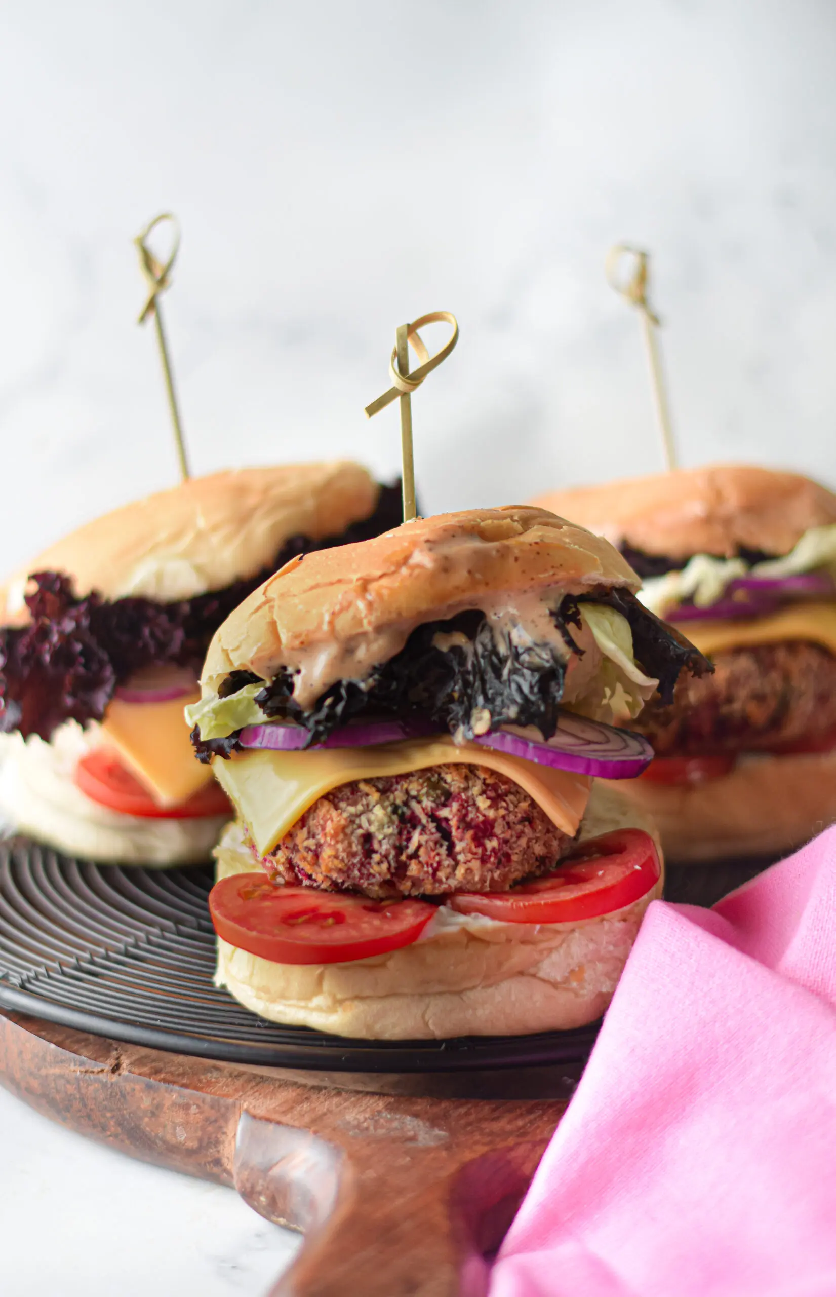 a plate of veggie burgers with toppings on them