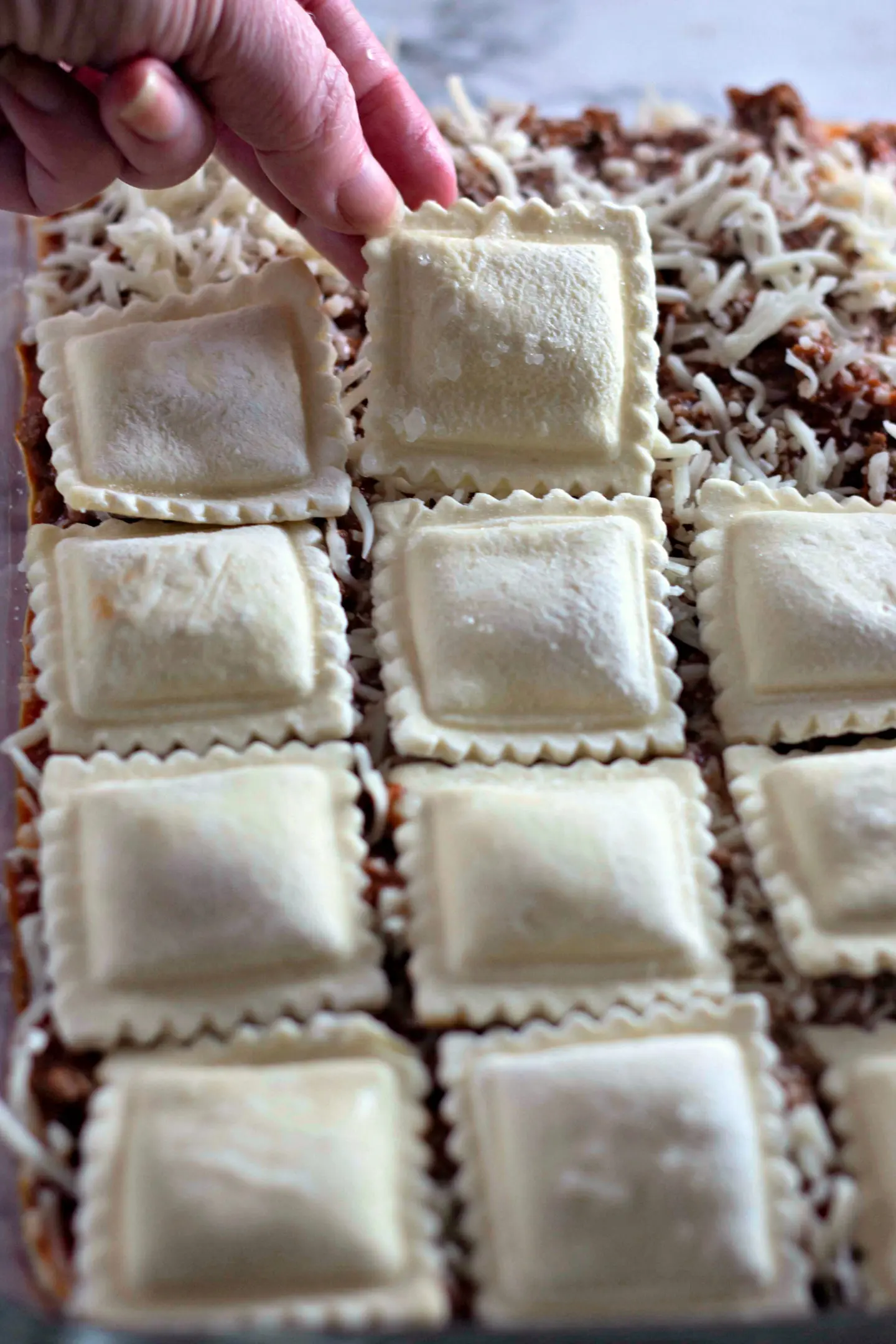 putting the frozen ravioli on the baked ravioli