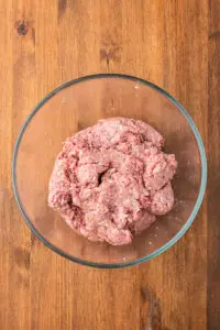 a bowl of ground meat for swedish meatballs