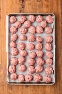 meatbalss ready to be cooked - on a cookie sheet