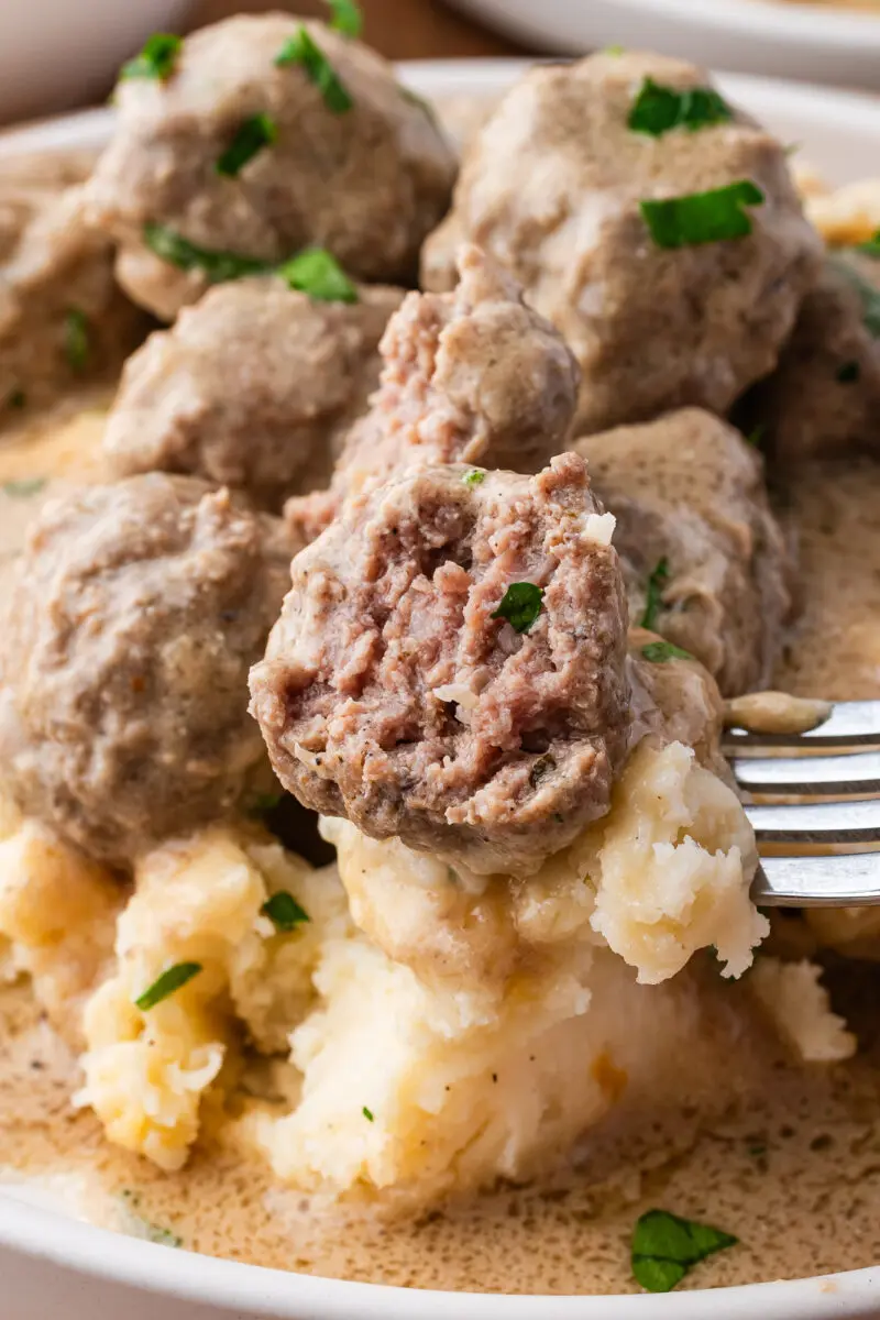 a swedish meatball and potatoes on a fork