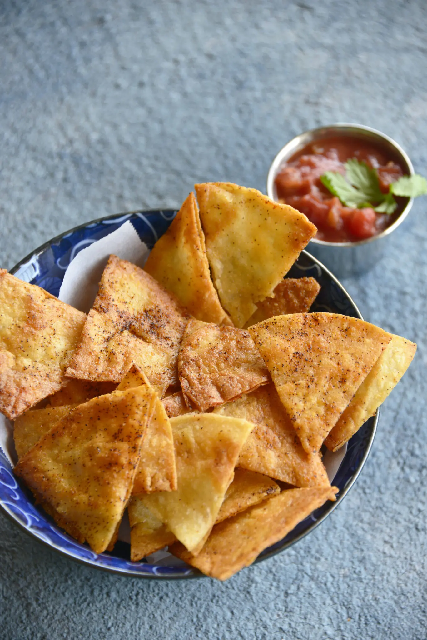 a bowl of baked homemade tortillas and dipping sauce.