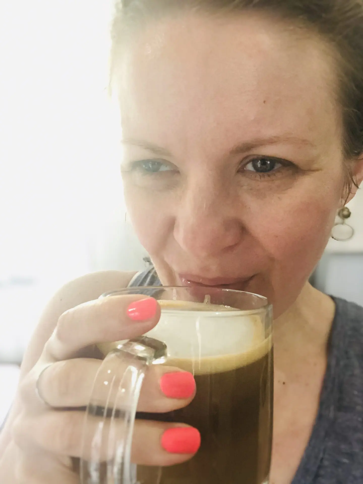 Janel from NellieBellie holding a mug of coffee