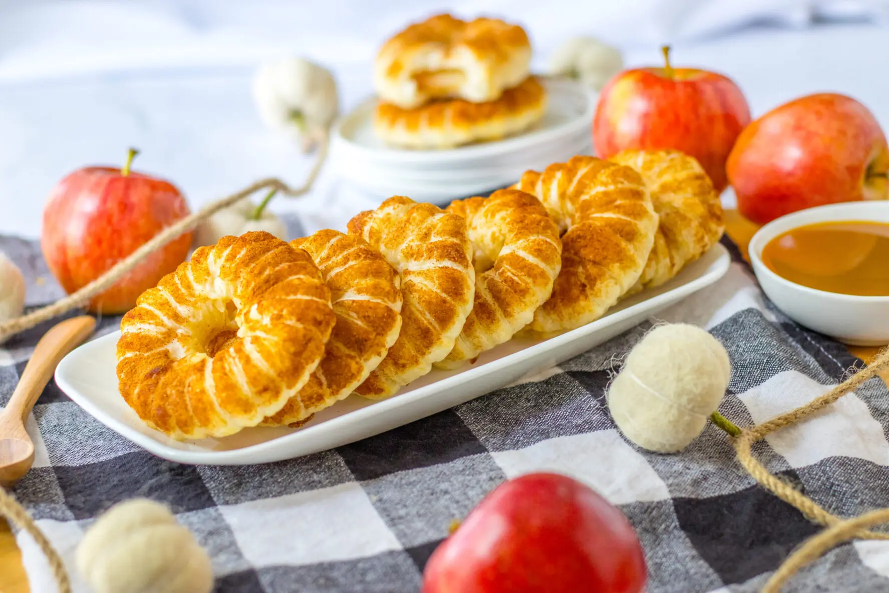 A plate of puff pastry apple donuts.