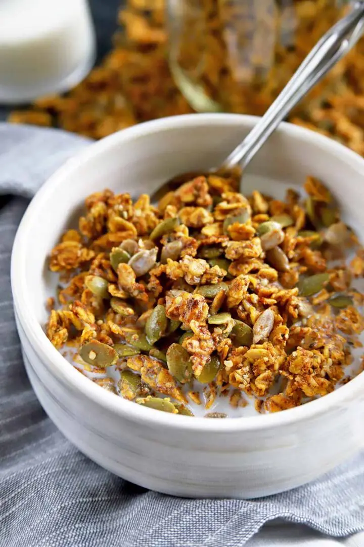 Bowl of pumpkin spice granola with pumpkin seeds.