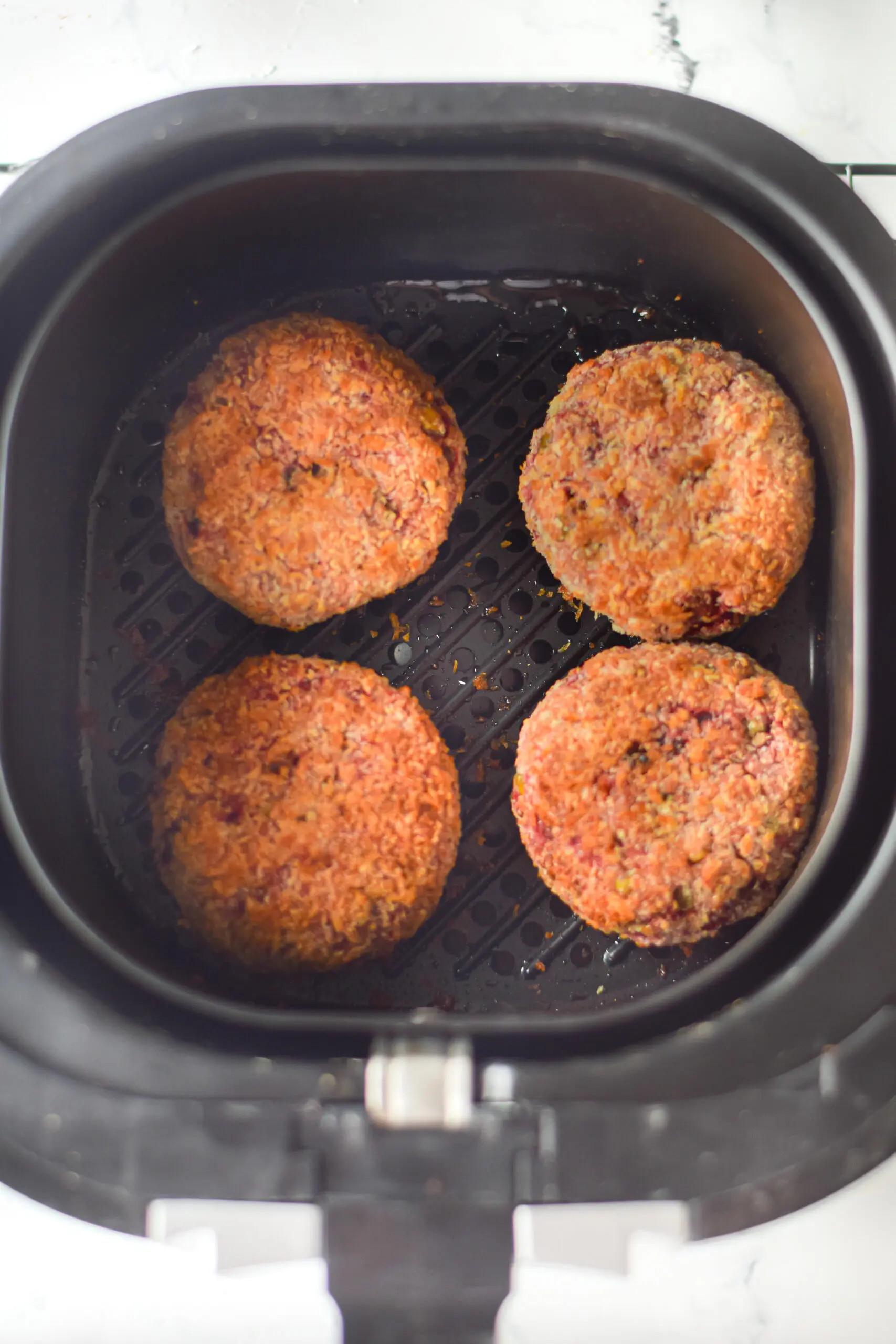 air fryer veggie burgers being fried
