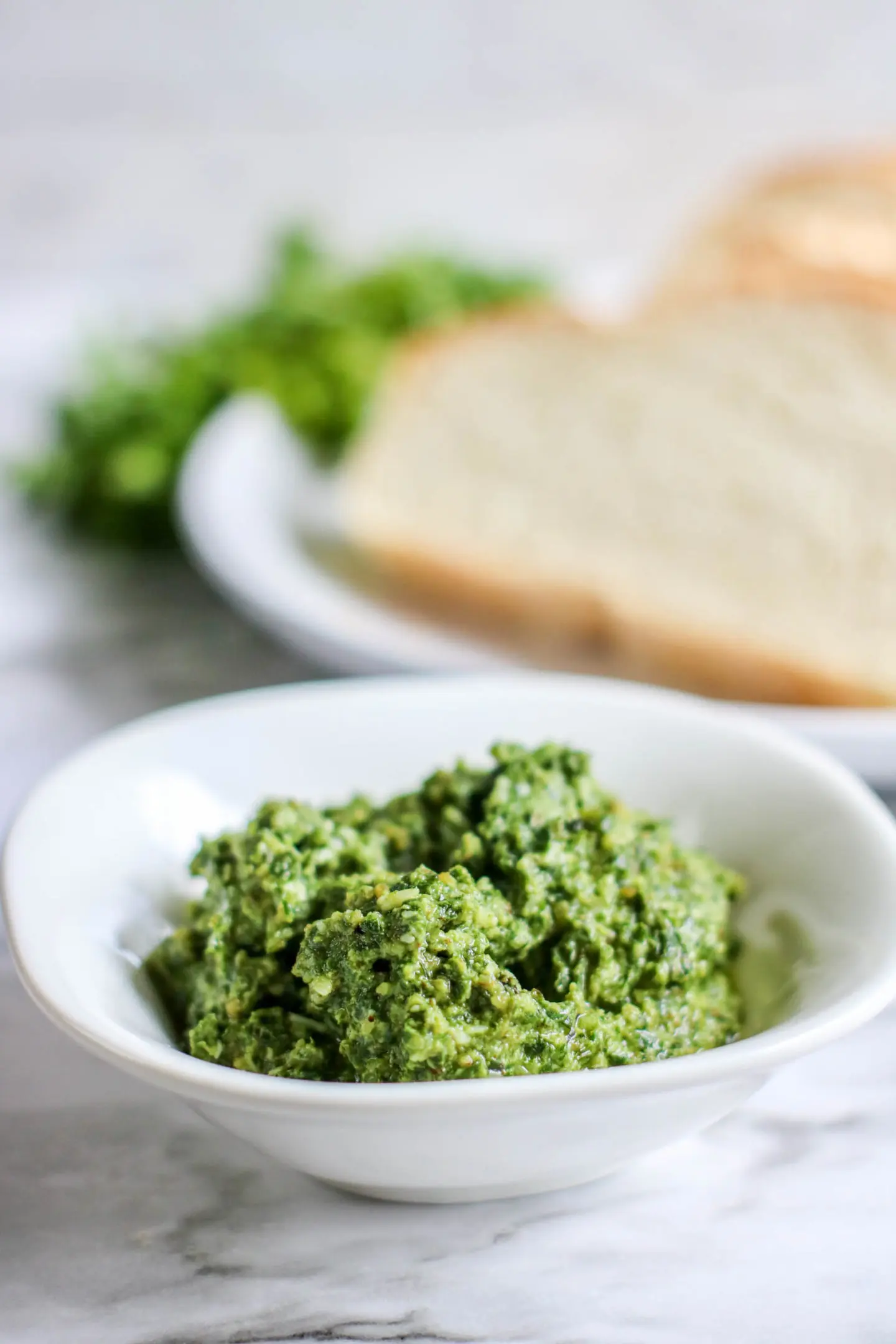 A bright green pesto that uses fresh basil and walnuts in the ingredients.