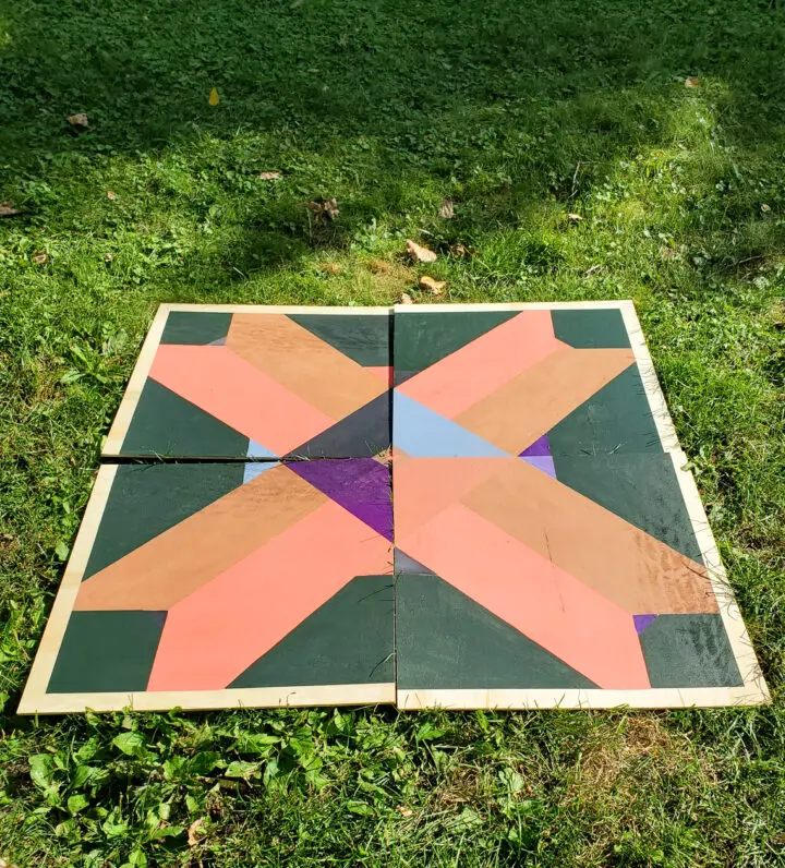 All of the squares of the diy barn quilt laid out together.