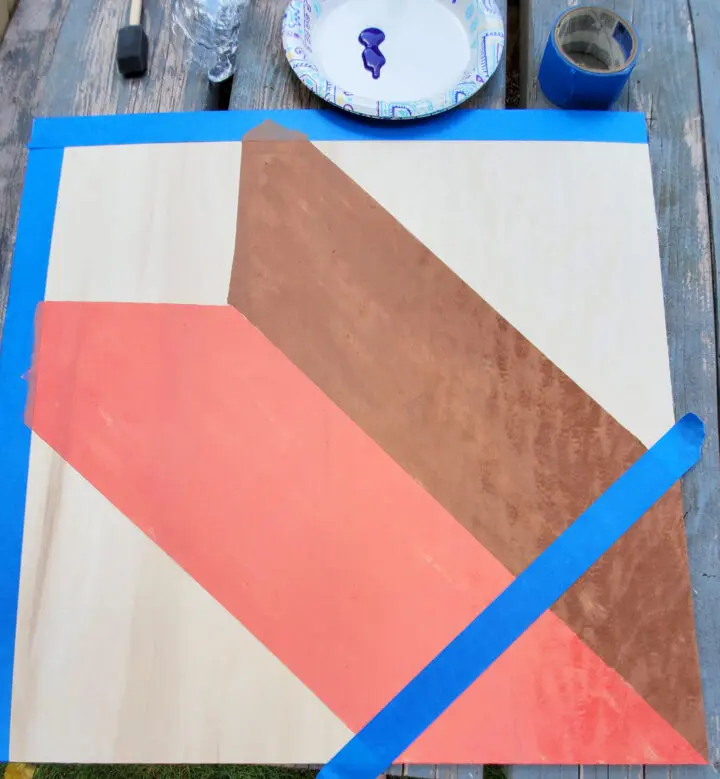 Taping up the diy barn quilt board for the center square