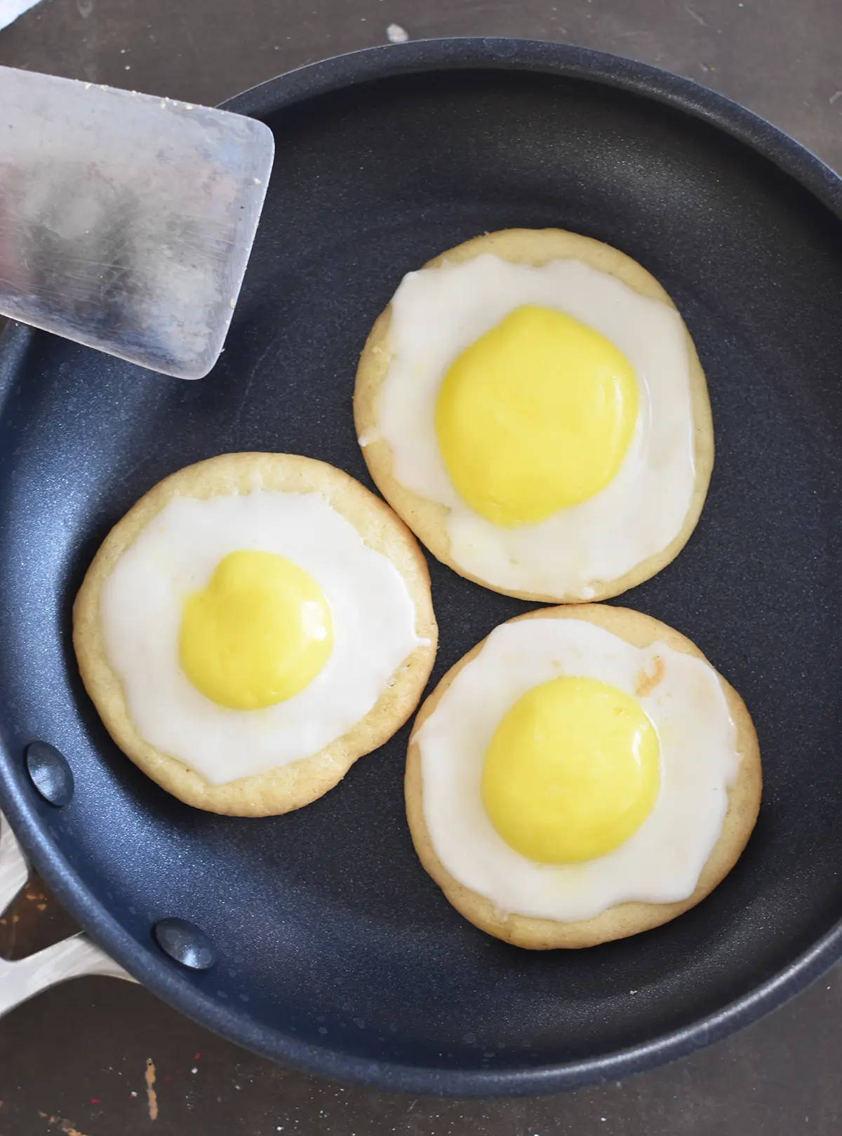 Cracked egg cookies in a skillet.