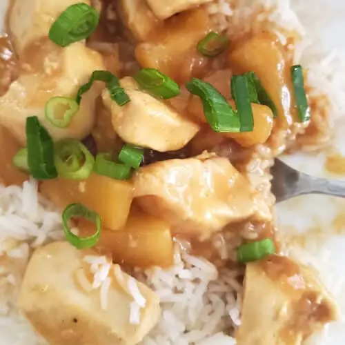 plate of chicken chunks served up with pineapple sauce for hawaiian chicken