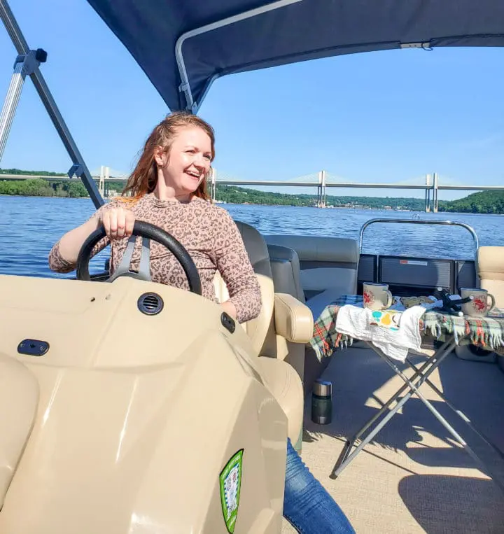 Janel driving a pontoon from Stillwater Boat rental on the St. Croix River