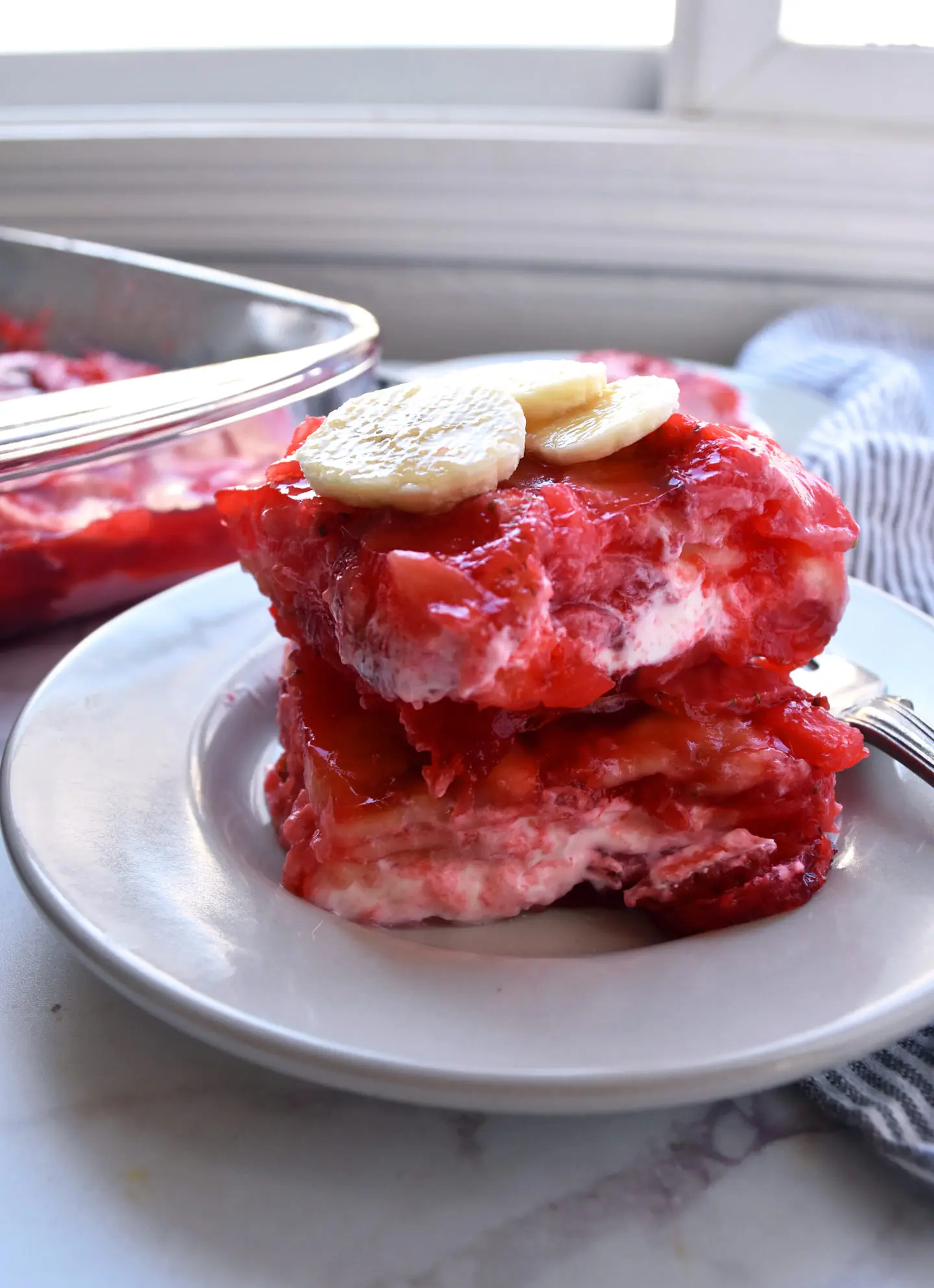 strawberry and banana jello salad on a plate