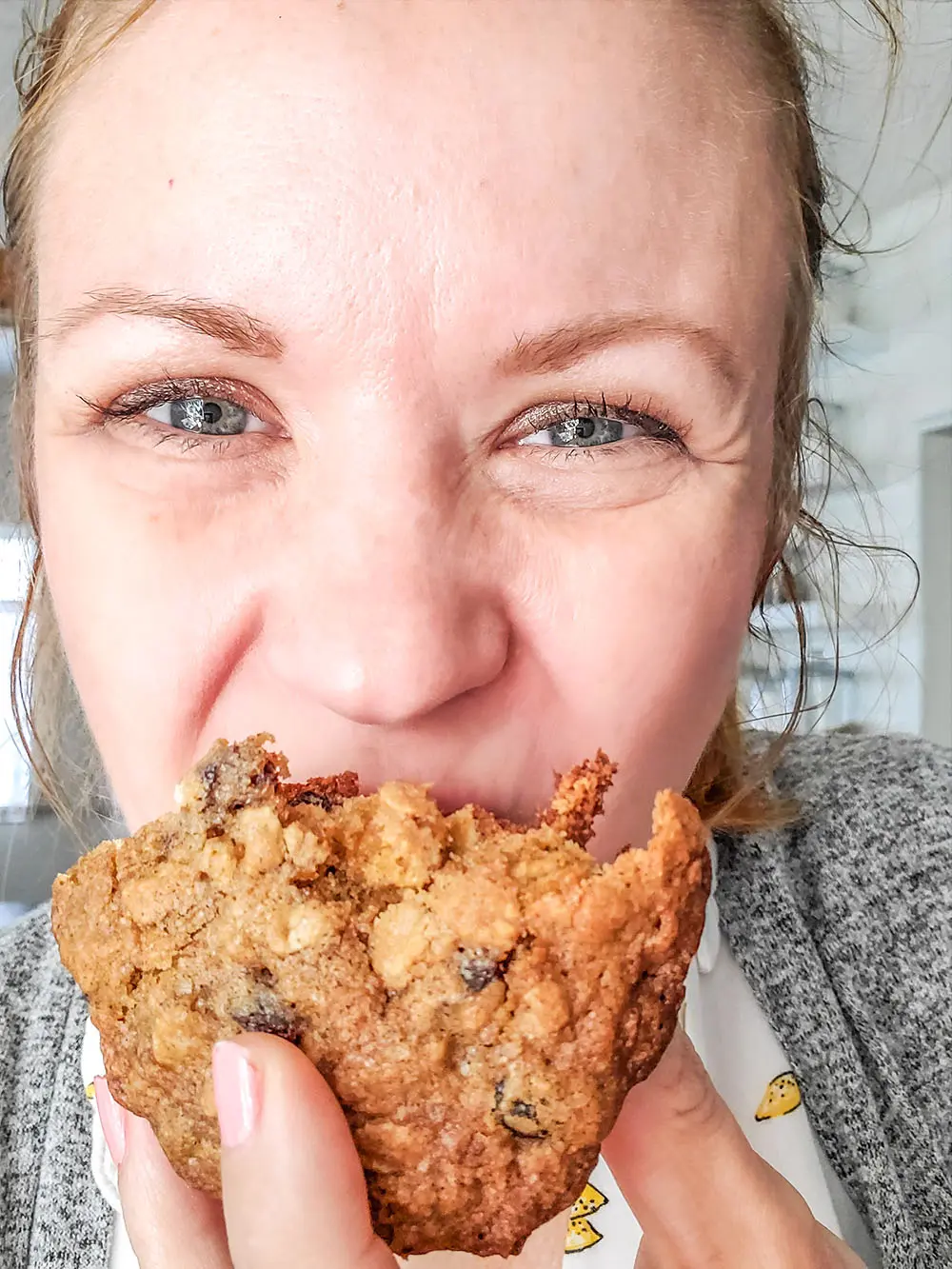 the BEST Oatmeal Raisin Cookie being held by Janel Hutton from NellieBEllie