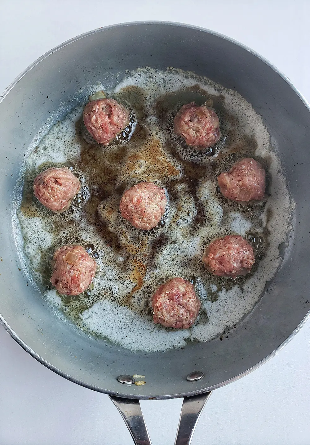 pan with meatblals being fried