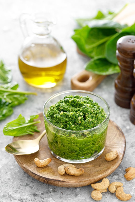 spinach pesto in a bwol with nuts and olive oil.