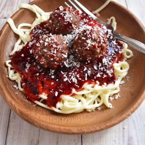 spaghetti and meatballs on a plate look just like the real thing but made with frosting, jam, and truffles. Great for April Fools Day!