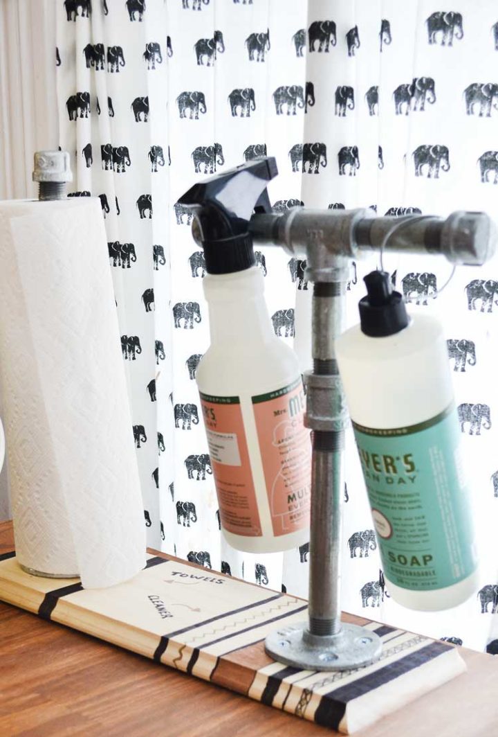 Full and easy tutorial for a pipe paper towel and cleaner holder by nelliebellie.com This is so easy to make and how great would that be to keep stuff organized!