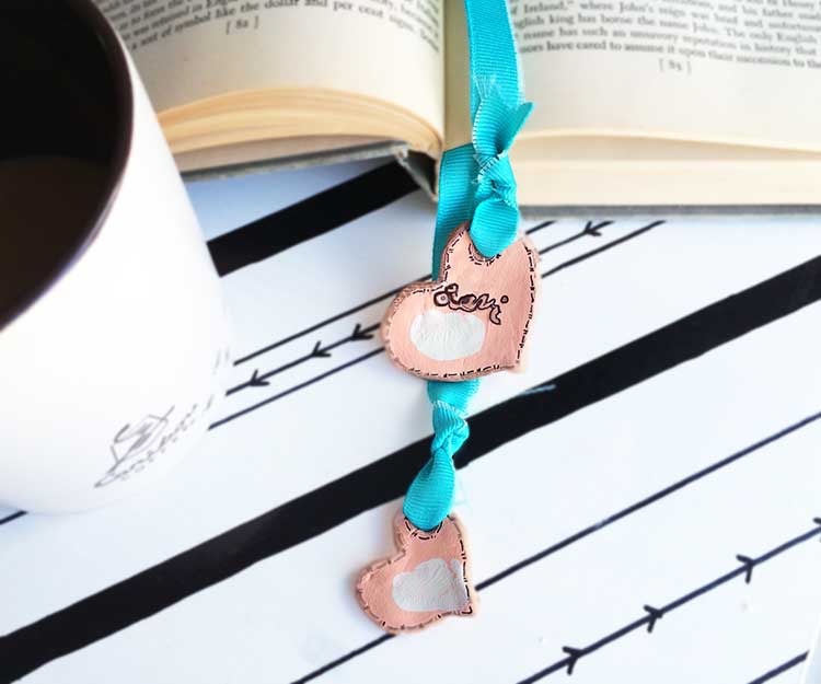 easy clay heart bookmarks. These are made with air-dry clay found at your local store. They are easy to make and great to personalize for Valentine's day with your child's thumbprint! Great idea for gifts.