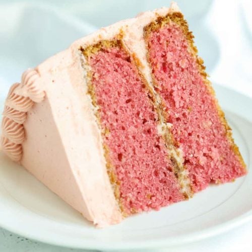 slice of homemade strawberry cake with strawberry frosting