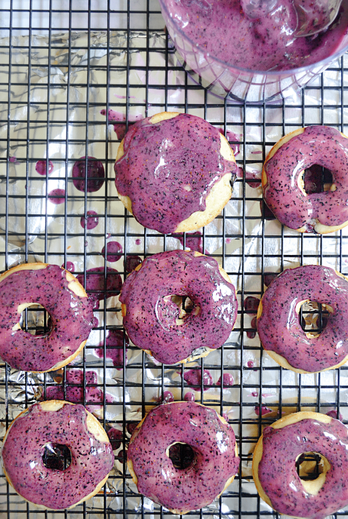 These baked yogurt donuts with fresh blueberry icing are fast and easy for busy parents! Kid's love them because of their sweet and bright blueberry flavor AND fantastic color. You'll love them because you can make them up in under 20 minutes.