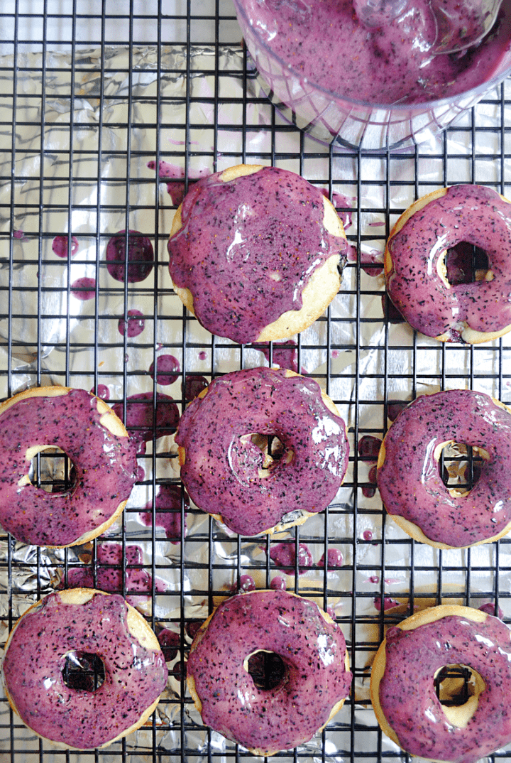These baked yogurt donuts with fresh blueberry icing are fast and easy for busy parents! Kid's love them because of their sweet and bright blueberry flavor AND fantastic color. You'll love them because you can make them up in under 20 minutes.