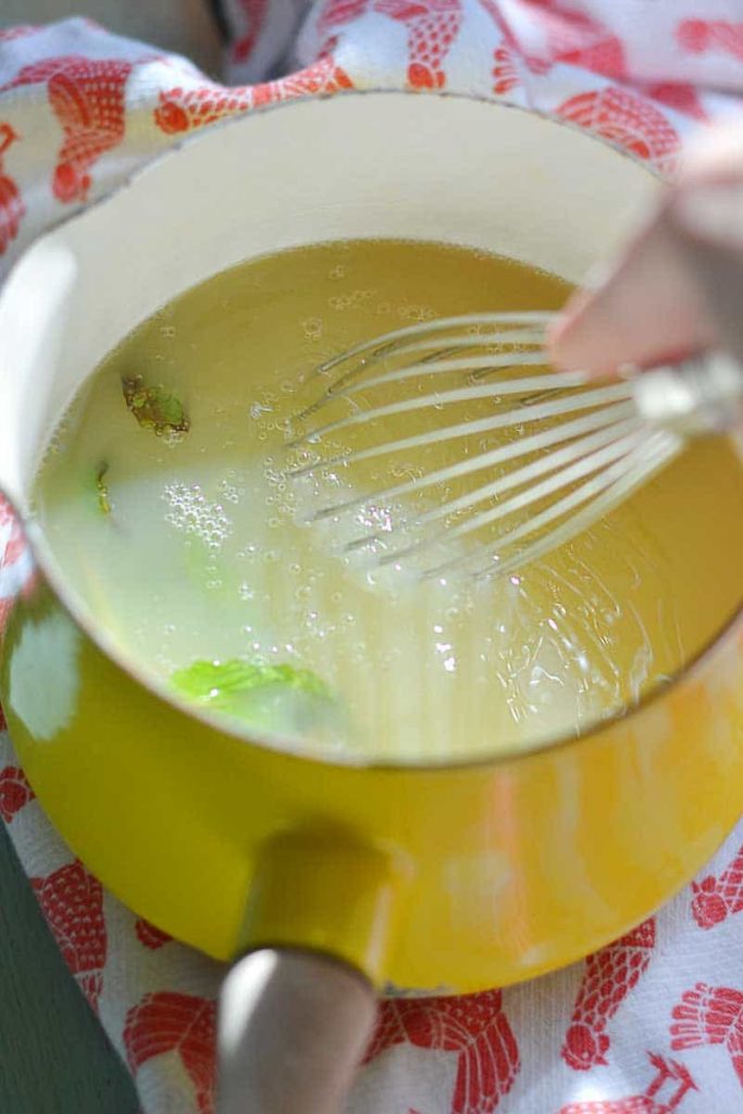 Homemade Margarita mix is so easy to make! This is a pan full of homemade lime and mint syrup for fresh and easy margarita's.