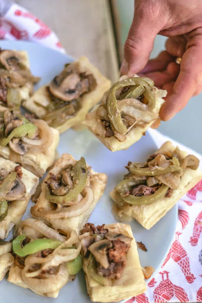 These little Philly Cheese Steak puffs are an easy, delicious appetizer with fresh veggies, flavorful beef, and buttery puff pastry. Easy, fast, and tasty!