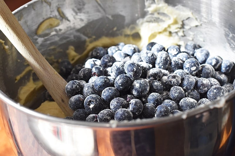 fold the blueberries gently into the blueberry sour cream bundt cake batter