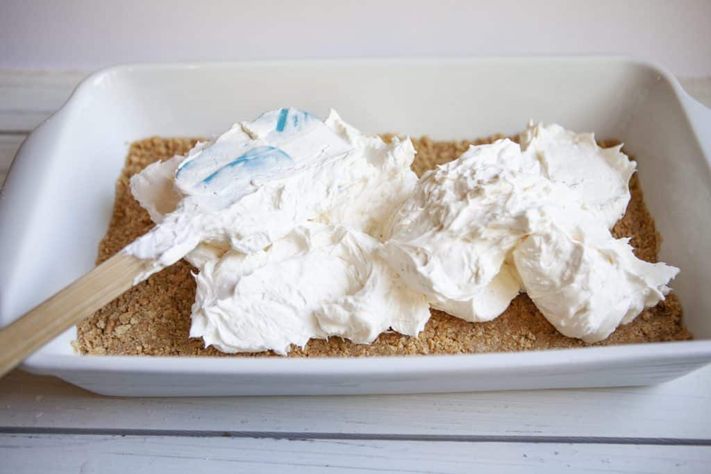 no bake cherry cheesecake filling spread over the crust