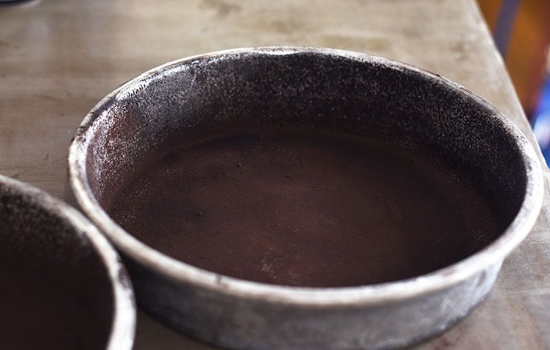 use cocoa to dust the bottom of your cake pans for this homemade chocolate cake