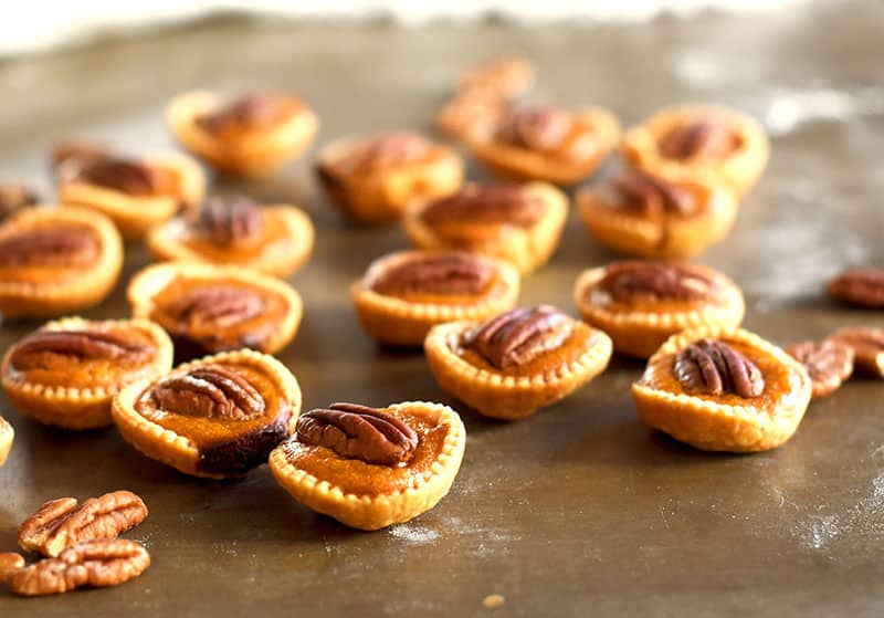 Mini pumpkin pies with a pecan on top. Pecan Pumpkin Pie bites that are easy to make!