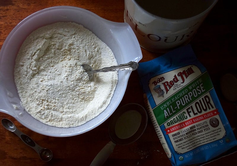 Flour mixture in a mixing bowl with Bob's Red Mill flour next to it.