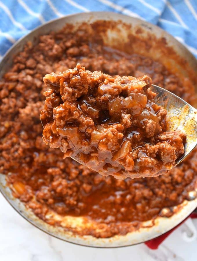 an easy and delicious sloppy joe sauce in a large spoon scooped from a skillet