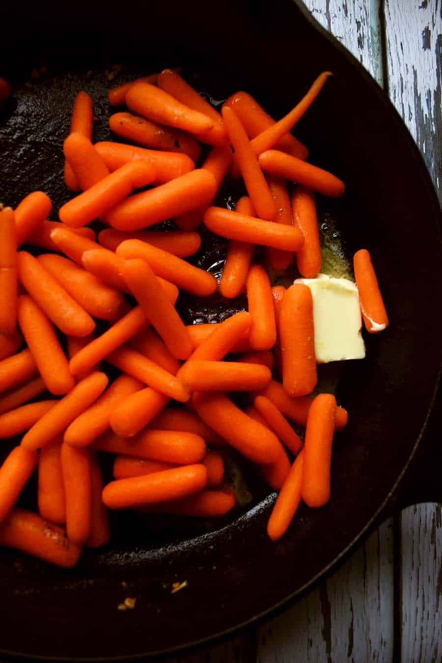 butter and baby carrots in skillet