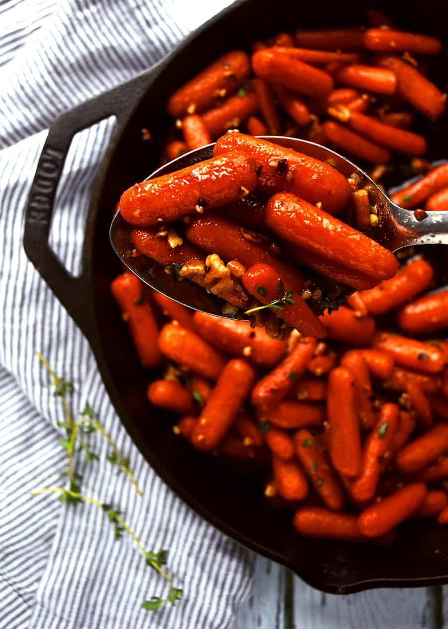 Whiskey glazed carrots in a spoon