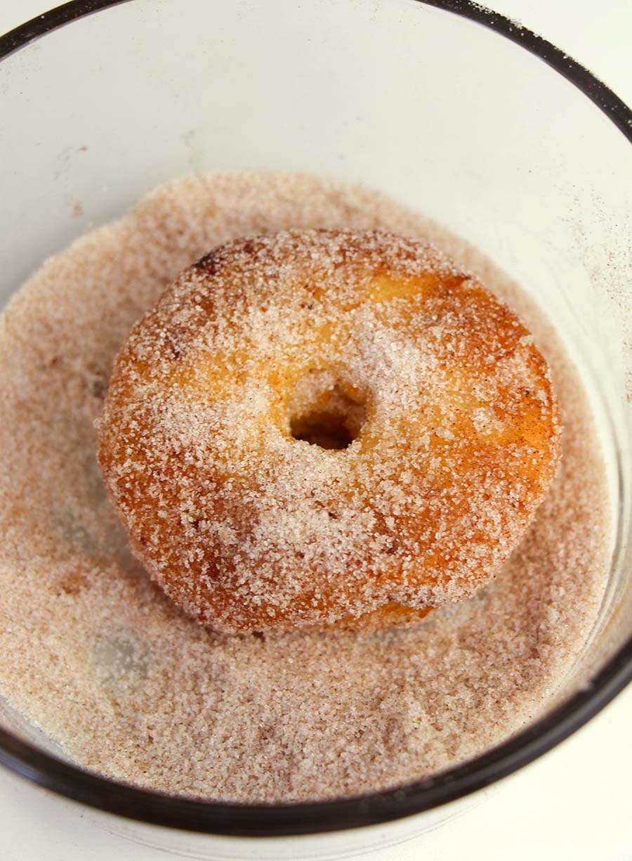 Dip fried biscuit dough shaped like doughnuts into a cinnamon sugar mixture.