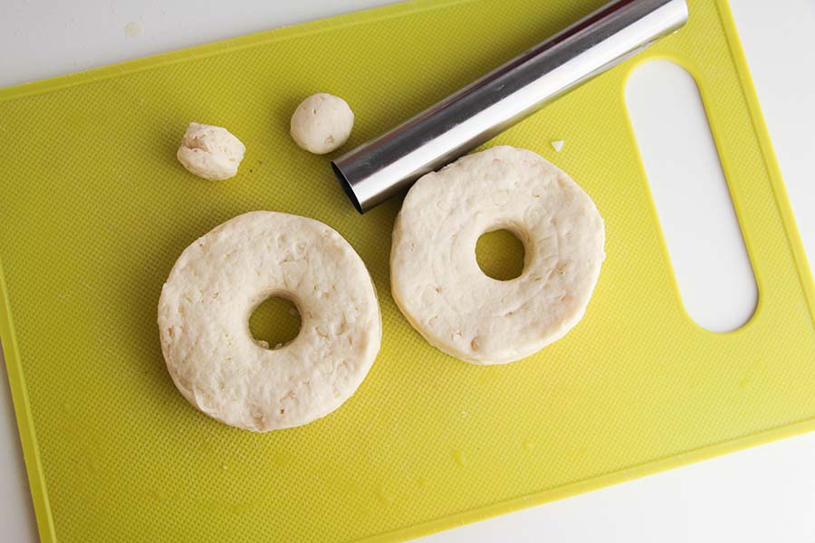 Canned biscuits are cut into doughnuts.